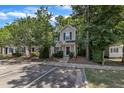 View of a two-story townhome with parking spots and a tree lined property at 3352 Tarleton W, Durham, NC 27713