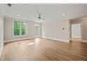 Spacious living room with lots of natural light, ceiling fan, and wood floors at 501 Finsbury St # 204, Durham, NC 27703