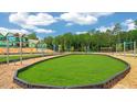 Well-maintained community playground with green lawn and bordered by woodchips, offering a safe recreational area at 553 Lemon Daisy Ln, Knightdale, NC 27545
