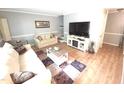 Comfortable living room with hardwood floors and neutral colors, perfect for relaxing at 5805 Mapleridge Rd, Raleigh, NC 27609
