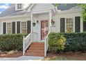 Charming two-story home featuring a brick walkway, beautiful landscaping, and a classic architectural design at 5908 Danville Dr, Raleigh, NC 27612