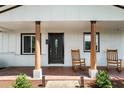 Cozy front porch with rocking chairs, wooden columns, and a decorative front door at 6005 Lake Wheeler Rd, Raleigh, NC 27603