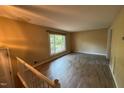 Living room with hardwood floors, large window, natural light and neutral paint throughout at 609 Sloan Dr, Cary, NC 27511