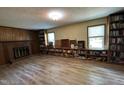 Spacious living room featuring a fireplace and built-in bookcases beneath the windows at 609 Sloan Dr, Cary, NC 27511