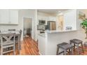 Beautiful kitchen features granite countertops, stainless steel appliances, and an adjacent dining area at 620 Rollins Mill Rd, Holly Springs, NC 27540