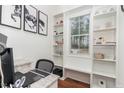 Bright home office featuring custom shelving, natural light, and stylish decor for a productive workspace at 620 Rollins Mill Rd, Holly Springs, NC 27540