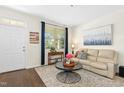 Inviting living room with hardwood floors, neutral paint, lots of natural light, and a comfortable sofa at 634 Stapleford Ln, Fuquay Varina, NC 27526