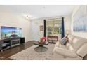Inviting living room with hardwood floors, neutral paint, lots of natural light, and a comfortable sofa at 634 Stapleford Ln, Fuquay Varina, NC 27526