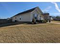 Side view of the home featuring vinyl siding, well maintained lawn and inviting curb appeal at 670 Meadowtop Cir, Burlington, NC 27217