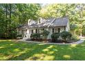 Classic home with a brick exterior, dormer windows, and a well-manicured lawn at 701 Bennington Dr, Raleigh, NC 27615