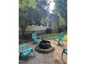 Backyard with fire pit area and Adirondack chairs, perfect for outdoor relaxation at 7801 Kingsbrook Ct, Wake Forest, NC 27587
