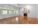 Bright living room with fireplace, hardwood floors, and many windows at 7801 Kingsbrook Ct, Wake Forest, NC 27587