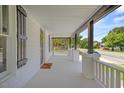 A comfortable and spacious front porch with stylish pillars and railings at 813 N Main St, Burlington, NC 27217