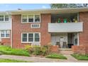 Charming brick apartment building with a covered balcony and well-maintained landscaping at 815 Daniels St # A, Raleigh, NC 27605