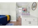 Open-concept living room with an adjacent dining area and modern white cabinetry at 815 Daniels St # A, Raleigh, NC 27605