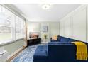 Bright living room boasts a large window, blue sectional sofa, and stylish decor at 815 Daniels St # A, Raleigh, NC 27605