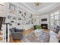 Inviting living room with custom shelves, hardwood floors, and a cozy fireplace at 8416 Davishire Dr, Raleigh, NC 27615