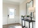 Bright entryway featuring wood floors, contemporary console table with decor, and a modern mirror at 88 Freedom Heights Ln # 148, Smithfield, NC 27577