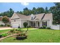 Well-maintained one-story home with a manicured lawn, beautiful landscaping, and an attached two-car garage at 904 E Ivy Valley Dr, Fuquay Varina, NC 27526