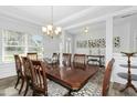 Elegant dining room with natural light, a large table, and stylish decor at 93 Kinsale Ct, Garner, NC 27529