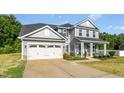 Charming two-story house with a wide driveway, attached garage, and inviting covered porch at 93 Kinsale Ct, Garner, NC 27529