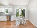 Cozy dining area with wood laminate flooring and views of the backyard at 1008 Alderleaf Dr, Fuquay Varina, NC 27526