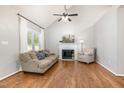 Inviting living room with vaulted ceilings, fireplace, and wood laminate flooring at 1008 Alderleaf Dr, Fuquay Varina, NC 27526