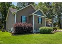 Single-story home featuring manicured front yard and landscaping at 102 Bluegrass Dr, Oxford, NC 27565