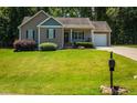 A charming single-story home with a well-manicured front lawn at 102 Bluegrass Dr, Oxford, NC 27565