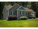 Charming single-story home with well maintained lawn and landscaping at 102 Bluegrass Dr, Oxford, NC 27565