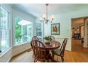 Cozy breakfast nook with beautiful views of the backyard and a charming chandelier that adds a touch of elegance at 10625 Soma Ct, Raleigh, NC 27613