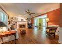 Bright living room features a fireplace, built-in shelving, and beautiful flooring, perfect for entertaining or relaxing at 10625 Soma Ct, Raleigh, NC 27613