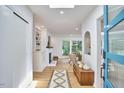 Bright foyer with wood floors, skylight, and an open view into the living room at 108 Cedar St, Chapel Hill, NC 27514
