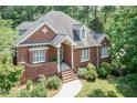 Beautiful brick home with manicured landscaping, white trim and a welcoming front porch at 109 Fox Trap Ct, Garner, NC 27529