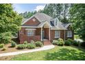 Stunning brick home with mature trees, well-kept landscaping, and classic architectural details at 109 Fox Trap Ct, Garner, NC 27529