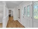 Bright entryway featuring hardwood floors and a decorative glass door with sidelights at 11100 Honeycutt Rd, Raleigh, NC 27614