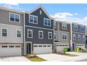 Row of elegant townhomes featuring coordinated design and individual garages at 1114 Crossvine Trl, Durham, NC 27703
