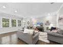 Bright living room featuring hardwood floors, neutral walls, and two comfortable sofas at 1125 Surveyor Dr, Durham, NC 27703