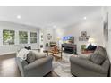 Cozy living room showcasing hardwood floors, a large window, and comfortable seating at 1125 Surveyor Dr, Durham, NC 27703