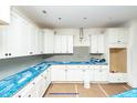 Bright new kitchen featuring white cabinets, blue countertops, and stainless steel appliances at 1229 Lawndale Dr, Graham, NC 27253