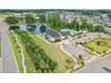Community center featuring a refreshing pool and recreational facilities near a serene pond at 125 Alumroot Rd, Holly Springs, NC 27540