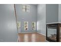 Bright living room featuring hardwood floors, a fireplace, tall ceilings, and large windows at 145 Mariah Towns Way, Garner, NC 27529