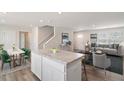 Open-concept living space with eat-in kitchen and hardwood floors, promoting a seamless transition for modern living at 16 Powder Ct, Angier, NC 27501