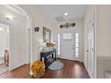 Inviting foyer with wood floors, console table, and decorative mirror creating a welcoming entry at 16 Woodglen Dr, Clayton, NC 27527