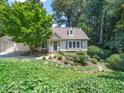 Beautiful home featuring lush greenery, a well-manicured lawn, and attached garage at 1708 Lake Park Dr, Raleigh, NC 27612