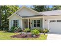 Close up of a home exterior showcasing a well-maintained garden and charming curb appeal at 174 Sequoia Dr, Louisburg, NC 27549