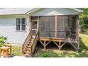 This home features an inviting screened porch accessible by a wooden staircase at 174 Sequoia Dr, Louisburg, NC 27549