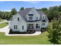 Stunning two-story home with a landscaped lawn, elegant porch, and modern farmhouse design at 20 Delia Ln, Pittsboro, NC 27312