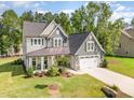 Beautiful two-story home with a manicured lawn, two car garage, and covered front porch at 220 W Amber Oak Dr, Selma, NC 27576