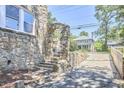 Unique stone arch detail with matching stone wall and exterior stairs at 2203 University Dr, Durham, NC 27707